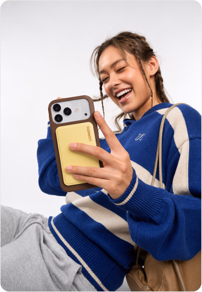 Smiling customer holding her iPhone in a Caseon case